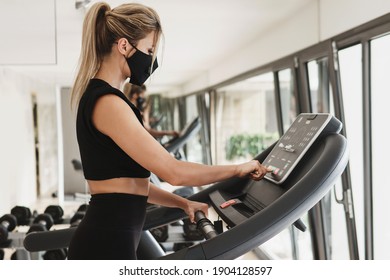 Gym New Normal. Young Athletic Woman Wearing A Prevention Face Mask During Her Fitness Workout.