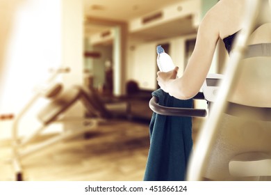 gym place background and blue towel and woman on bike  - Shutterstock ID 451866124