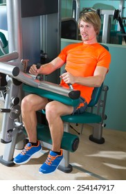 Gym Seated Leg Curl Machine Exercise Blond Man At Indoor