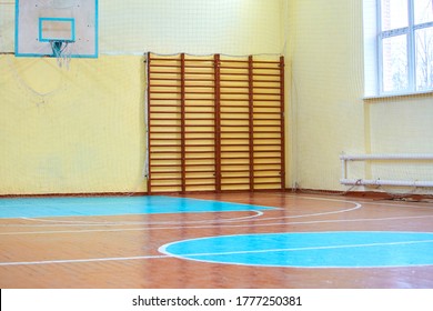 Gym For Sports Classes At School Or College. Swedish Wall, Stairs, And Wooden Floor With Markings For Volleyball.