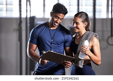 Gym subscription, personal trainer and happy client talking and ready to fill in a membership form. Fitness coach discussing training, workout plan and progress in a health and wellness facility - Shutterstock ID 2191542161
