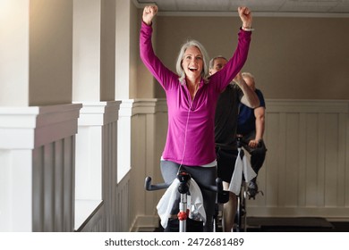 Gym, success or happy woman on cycling bike in workout or cardio training for progress, health or wellness. Class, exercise or proud senior person on bicycle machine for fitness, challenge or goal - Powered by Shutterstock