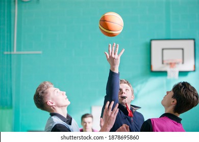 Gym Teacher Starting A High School Basketball Game With The Tip Off.