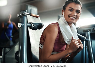 Gym, towel and woman with smile, fitness break and warm up for intense weight performance. Sport, earphones and female athlete ready for workout, training and chest press exercise for strength - Powered by Shutterstock