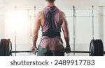 Gym, weightlifting and back of man for exercise, deadlift and strong arm muscle development. Fitness, bodybuilding and serious body builder with health, workout or power training at sports club