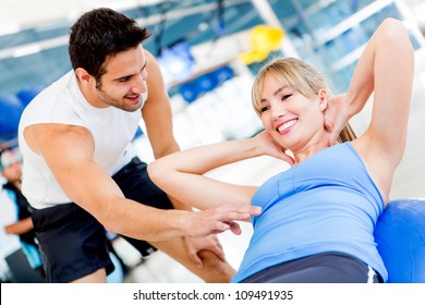 Gym woman exercising with her personal trainer - Powered by Shutterstock