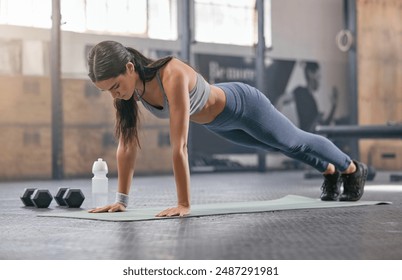 Gym, woman and workout with push ups for muscle or body building for wellness, wellbeing and self care. Female person, training centre and serious with exercise or training for fitness and strength - Powered by Shutterstock