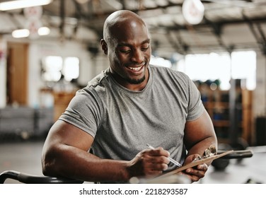 Gym, workout and personal trainer with checklist on clipboard consulting for training sports in gym. Black man of muscular, active and smiling fitness coach writing on health, wellness and exercise - Powered by Shutterstock