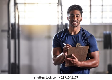 Gym, workout and personal trainer with clipboard consulting at a training sports in gym. Portrait of muscular, active and smiling fitness coach writing on health, wellness and exercise with flare - Powered by Shutterstock