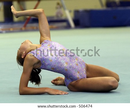 gymnast on floor in the finish position