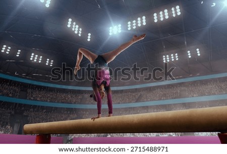 A gymnast performs a difficult trick on a balance beam.