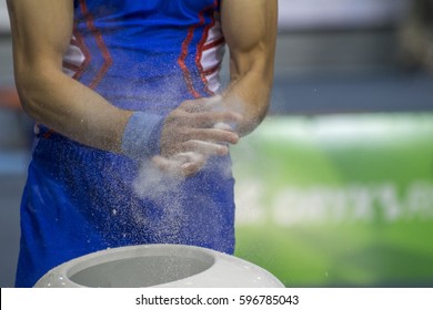 gymnast prepares hands for performance - Powered by Shutterstock