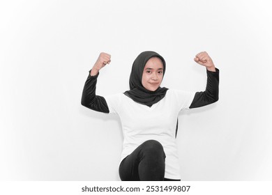 Gymnastic movements of women wearing hijabs in white clothes, two hands bent to the side, one leg lifted - Powered by Shutterstock