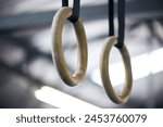 Gymnastic rings, gym and workout for aerobics, fitness and strong or power challenge for training. Equipment, tool and flexibility exercise or sports for wellness, arena and gear for competition