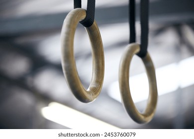 Gymnastic rings, gym and workout for aerobics, fitness and strong or power challenge for training. Equipment, tool and flexibility exercise or sports for wellness, arena and gear for competition - Powered by Shutterstock