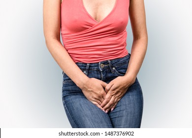 Gynecologic Problems, Urinary Incontinence, Female Health. Woman Holds Hands  Between Her Legs