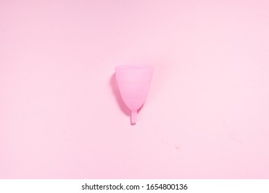 Gynecological Health, Menstruation Product Is A Pink Silicone Menstrual Cup For Critical Days, Zero Waste And Healthy Lifestyle Concept. Feminine Sanitary Product. Flat Lay, Top View.