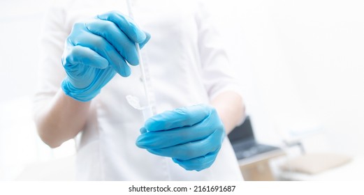 Gynecologist In Blue Gloves Is Taking Smear Analysis For Research Detect Sexually Transmitted Diseases And HPV. Banner Copy Space White.