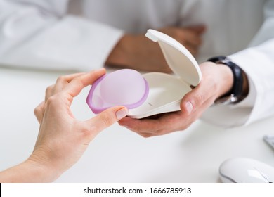 Gynecologist Consulting Woman On Diaphragm Contraception And Birth Control Method