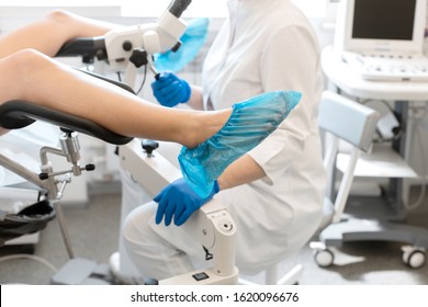 A gynecologist is examined by a patient who is sitting in a gynecological chair. Examination by a gynecologist. Female health concept. - Shutterstock ID 1620096676