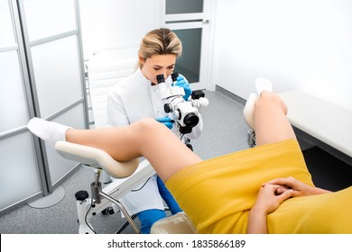 Gynecologist Examines The Uterine Cavity Using A Colposcope. Colposcopy, Examination Of The Cervix. Diagnosis Of Cervical Ectropion