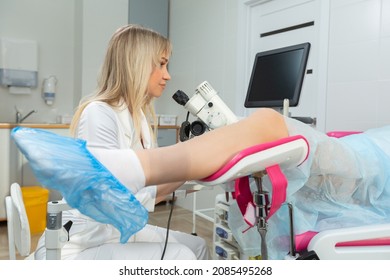 A Gynecologist Performs A Colposcopy On A Young Girl In A Gynecological Chair In A Modern Medical Office. Prevention And Diagnosis Of Cervical Cancer