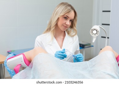 A Gynecologist Performs A Colposcopy On A Young Girl In A Gynecological Chair In A Modern Medical Office. Prevention And Diagnosis Of Cervical Cancer