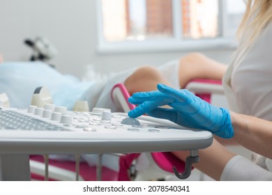 A gynecologist performs an ultrasound diagnostic procedure for a girl lying in a gynecological chair. Pregnancy management, fetal health monitoring - Shutterstock ID 2078540341