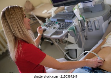 Gynecologist Performs Ultrasound Scan On Young Woman With Problems Of Female Reproductive System. Diagnosis Of Early Pregnancy Concept