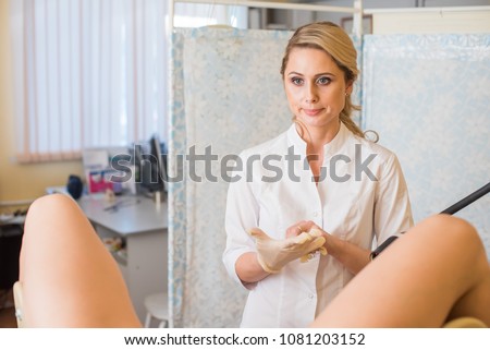 A gynecologist wears gloves. Gynecological office. Gynecologist inspects