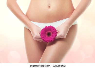 Gynecology concept. Young woman with flower on color background