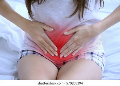 Gynecology concept. Young woman suffering from pain at home