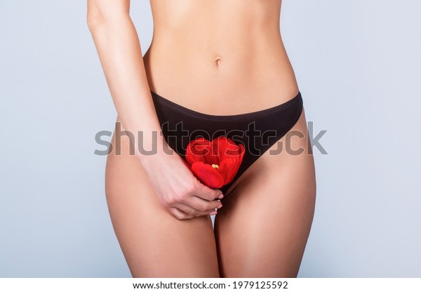 Gynecology, menstruation, concept of woman\
genital health. Gynecology concept. Young woman flower on white\
background. Gynecology and underwear, women health. Youth and\
freshness, purity,\
flowering.