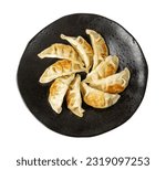 Gyoza Chinese Dumplings Isolated, Fried Vegetable Jiaozi, Chicken Momo Pile, Asian Gyoza Group on Black Plate, White Background Top View