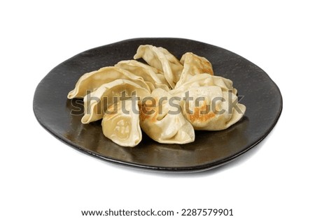 Gyoza Chinese Dumplings Isolated, Fried Vegetable Jiaozi, Chicken Momo Pile, Asian Gyoza Group on Black Plate, White Background