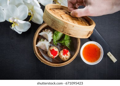 Gyoza, Japanese Dumplings. Steam Chinese Food Of The Steaming Gyoza In Wicker Basket
