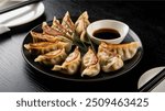 Gyoza : Japanese pan-fried dumplings filled with minced pork, cabbage, and garlic chives, served with a dipping sauce. Inspired by Chinese jiaozi, they’re a popular street food.