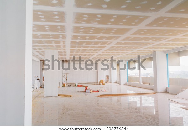 gypsum board ceiling structure and plaster mortar\
wall painted foundation white decorate interior room in building\
construction site