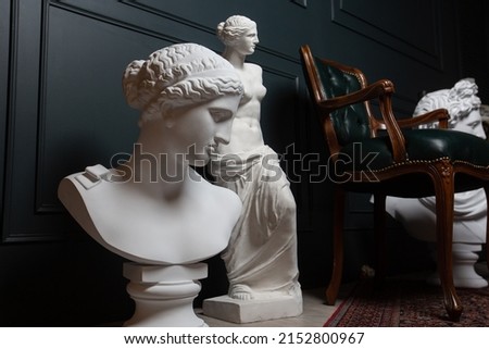 Gypsum copy of ancient statue Apollo, Aphrodite and Venus statue on dark textured background. Plaster sculpture face