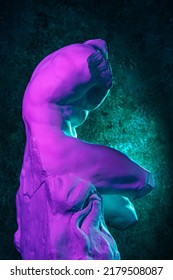 Gypsum copy of Belvedere Torso statue for artists. Replica of a famous ancient Greek fragmentary marble sculpture of male nude in color neon light. Template design for art, dj, fashion, poster, zine.