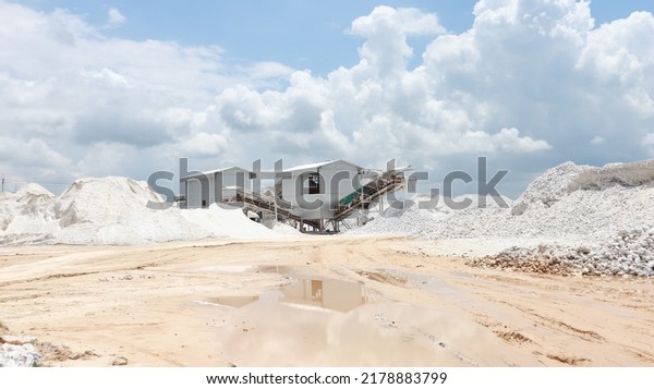 Gypsum grist mill in gypsum mining industry area\
with blue sky and white cloud background, Semi Precious white gem\
deposit or mining grist\
mill