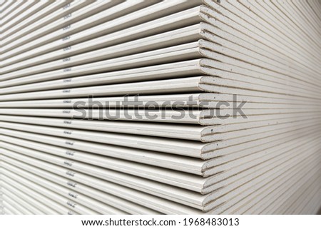 Gypsum plasterboard in the stack prepared for construction. Construction Materials. Drywall storage.
