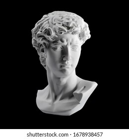 Gypsum statue of David's head. Michelangelo's David statue plaster copy isolated on black background. Ancient greek sculpture, statue of hero