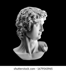 Gypsum Statue Of David's Head. Michelangelo's David Statue Plaster Copy Isolated On Black Background. Ancient Greek Sculpture, Statue Of Hero