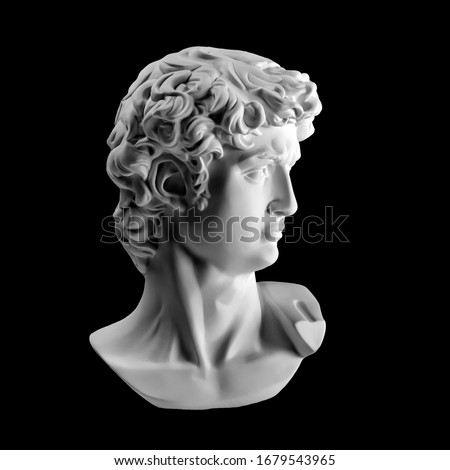 Gypsum statue of David's head. Michelangelo's David statue plaster copy isolated on black background. Ancient greek sculpture, statue of hero