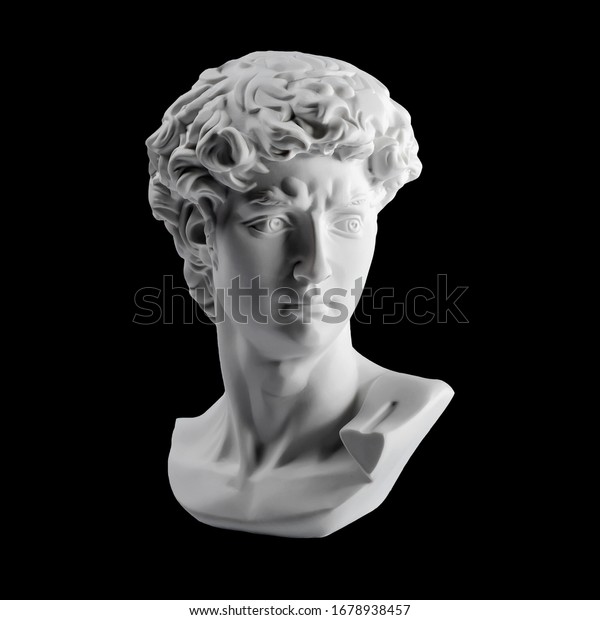 Gypsum statue of David\'s head. Michelangelo\'s David\
statue plaster copy isolated on black background. Ancient greek\
sculpture, statue of\
hero