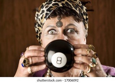 Gypsy looking at an eight ball to predict the future