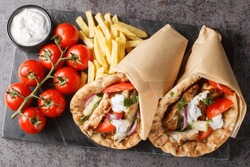 Gyros Souvlaki Wrapped In A Pita Bread Closeup On The Board On The Table. Horizontal Top View From Above
