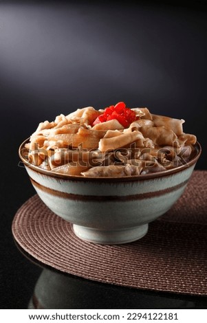 Gyudon, Japanese beef on rice bowl on black background.