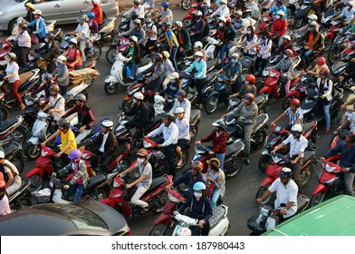 HA HOI, VIET NAM- APRIL 18: Amazing traffic of Asia city, group citizen on private vehicle in rush hour, colorful scene, mob of people in helmets, riding motorcycles, Hanoi, Vietnam, April 18, 2014